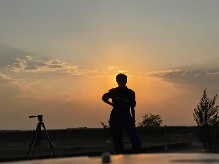 An AstroTours.org field observer and tripod at sunset in southeast Colorado near Kim.